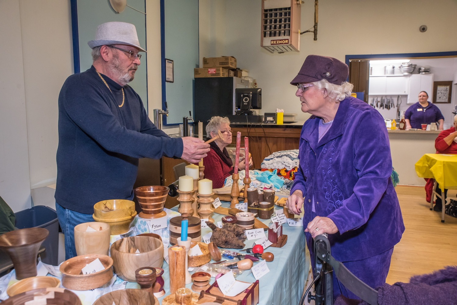 The Legion Hall in Osoyoos was a busy place Saturday morning as many people came to do their Christmas shopping at the Kiwanis Christmas Craft Fair. Gayle Kienas (left) of Penticton and Lyn Silverthorn of Osoyoos chatted as they manned their booths selling table cloths and other sewing and preserves. (Richard McGuire photo)