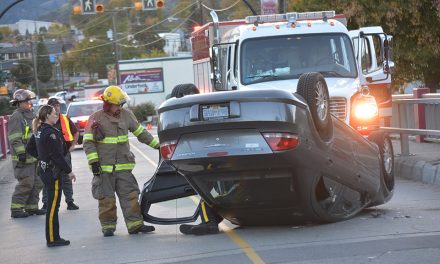 Car overturns on bridge