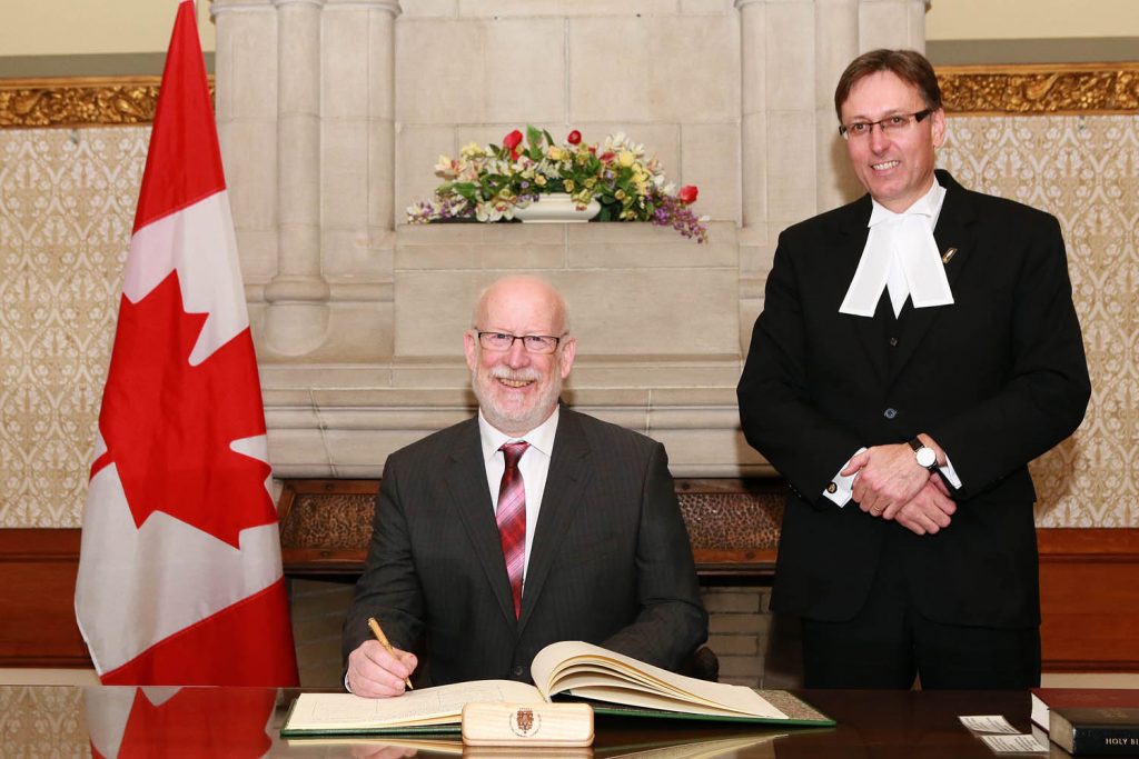Newly elected Member of Parliament Richard Cannings signs the register after being sworn into office last month. NDP Leader Tom Mulcair recently named Cannings as critic for post-secondary education and deputy critic for natural resources. Cannings has been busy setting up two offices in the constituency and one in Ottawa. (Photo supplied)