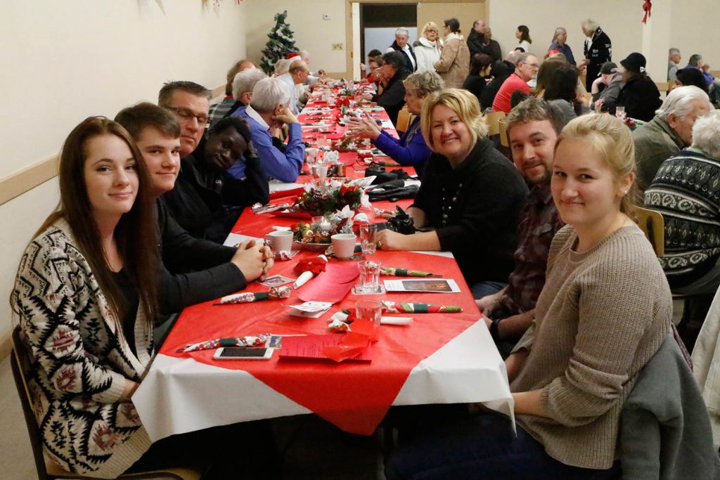 The Aspell family is among those waiting for Christmas dinner on Sunday at the Osoyoos Baptist Church. The dinner was open to the entire community. (Colin Stark photo)