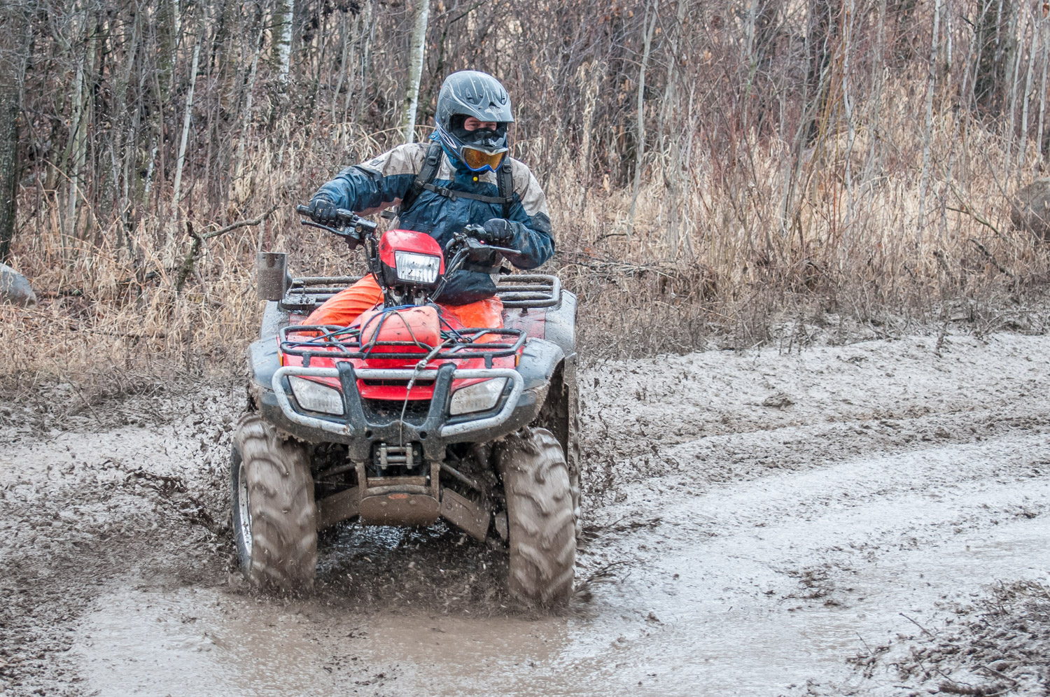 An ATV races through a bog in this file photo. When this is done in more sensitive wetlands, it can cause damage to habitat of endangered species. (© Richard McGuire file photo)