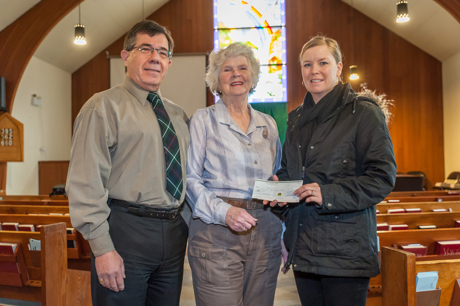 Rev. Stephen Hershey of Osoyoos United Church (left) and Joan Shirriff, volunteer manager of the thrift shop and a member of the worship committee (centre) hand over a cheque to Sandy Summers, co-chair of Desert Sun Counselling. The church raised $537 at its Christmas Eve service and each year it supports a different local charity. The church's thrift shop also contributes about $18,000 to causes in the community each year. (Richard McGuire photo)