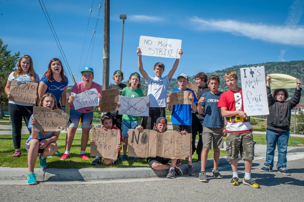 By mid morning Wednesday, the number of students protesting the teachers' strike at Osoyoos Elementary School had grown to about 15. An original five walked out of a morning assembly to stand in front of the school with handmade signs. They were soon joined by other students chanting "no more strike!" The students said they are fed up with being pawns in repeated labour disputes and some were especially critical of their teachers, while not letting the government off the hook. Principal Bo Macfarlane said the school doesn't sanction their activities, but said it can't use force to stop them. (Richard McGuire photo)