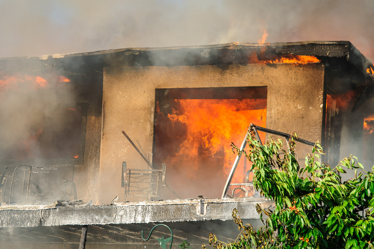 A house on 33rd Street on the Osoyoos East Bench was engulfed in flames Wednesday evening. (Richard McGuire photo)