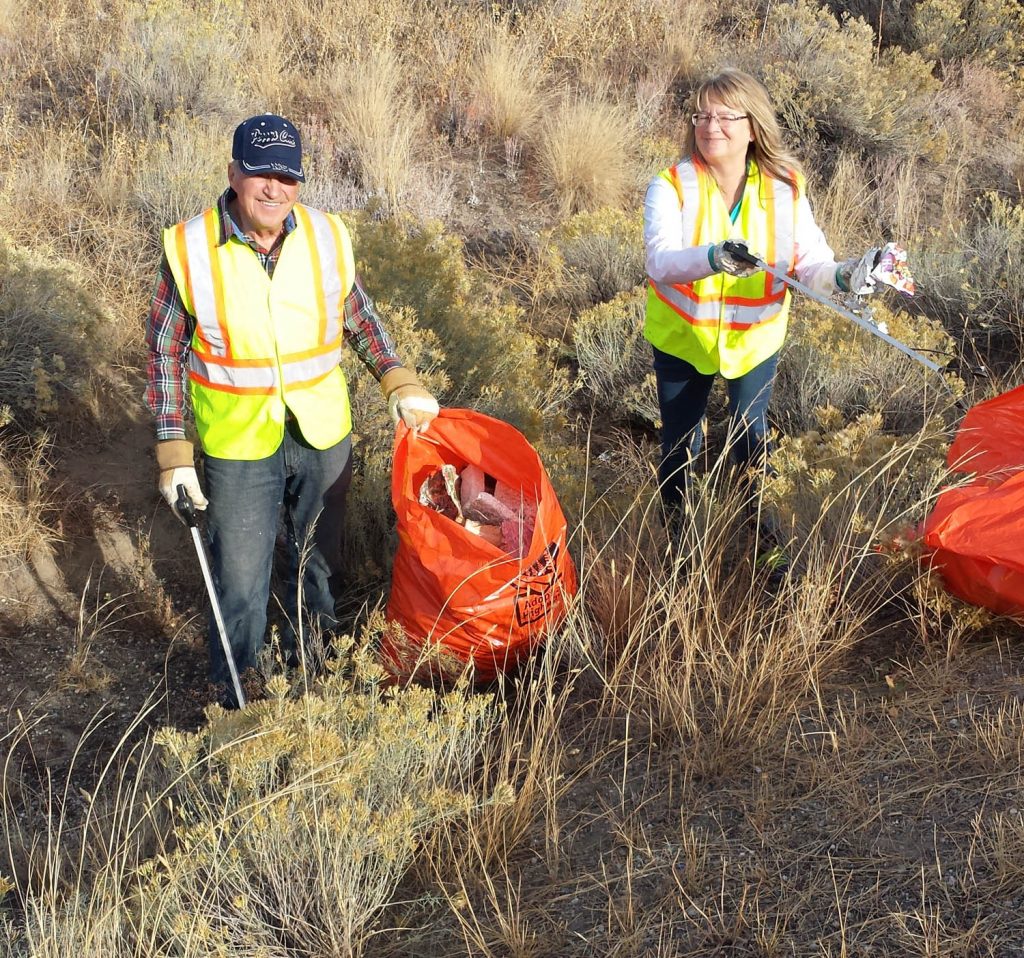 Lynda Bliss (right), the Interior Savings branch manager in Osoyoos, joins Osoyoos Rotarian Harold Cox in doing some road clean-up in the 2015 Day of Difference, when Interior Savings employees volunteer to help community groups with projects. Bliss is also a member of the Rotary Club of Osoyoos. (Photo contributed)