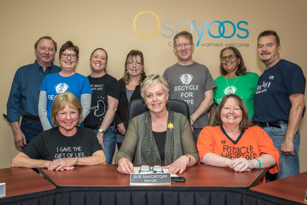 Osoyoos Mayor Sue McKortoff (front row centre) last week declared April to be Organ and Tissue Donation Awareness Month in Osoyoos. Attending the proclamation were kidney donors and recipients from Osoyoos and elsewhere in the South Okanagan. The goal of the month, marked across North America, is to raise awareness about organ donation and to encourage people to register to donate organs in the event of their death as well as to consider being a living donor. Back row from left are: Sam Kootnikoff, Judy Sloan, Annick Lim, Lynn Cunningham, Terry Craig, Teresa Atkinson and Brian Rawlings. Front from left are: Betty Kootnikoff, McKortoff and Laura Craig. Betty Kootnikoff donated a kidney to her husband Sam, both of Penticton. Terry Craig donated a kidney to his wife Laura, although she has since needed another transplant. Sloan, Lim and Cunningham are kidney recipients. Atkinson, from Okanagan Falls, has been a recipient, but is waiting for a new kidney. Rawlings recently donated a kidney to Julie Wolter of Osoyoos, who is currently in Vancouver recovering from the operation. The Craigs live in Penticton, but Terry Craig has been promoting kidney donation through his accounting business Kemp Harvey Craig in Osoyoos. (Richard McGuire photo)