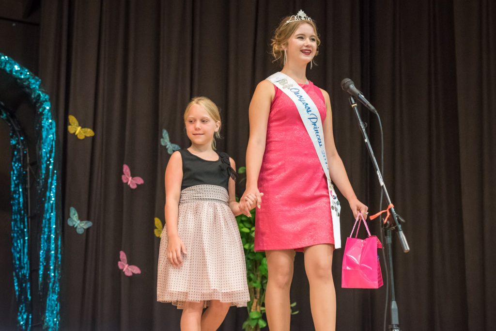Outgoing Princess Ali Hutter (right) arrives with her little buddy Kaitlyn Hillson. (Richard McGuire photo)
