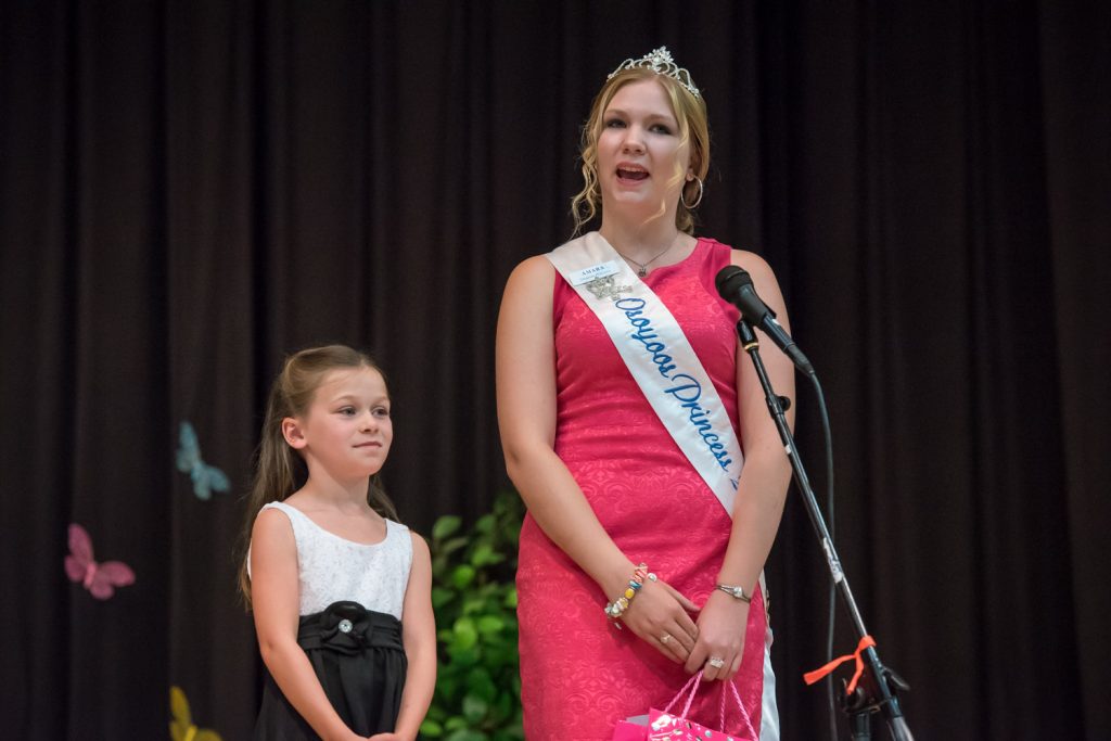 Outgoing Princess Amara Leeson (right) arrives with her little buddy Gyll Burton. (Richard McGuire photo)