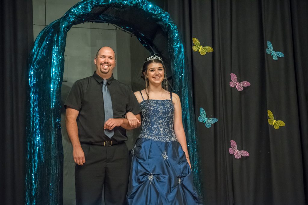 Contestant Tianna Morgan arrives on stage wearing her gown and accompanied by her father Derek Morgan. (Richard McGuire photo)