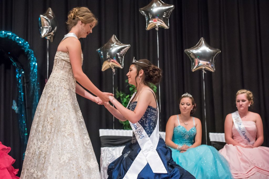 Outgoing Princess Ali Hutter helps new Princess Tianna Morgan get up after she crowned her. Looking on are new Princess Bailey Toepfer and outgoing Miss Osoyoos Teagen Aspell. (Richard McGuire photo)