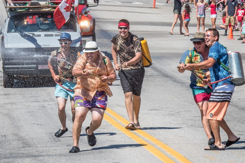 Osoyoos firefighters lead an opening attack on hordes of children armed with water guns. The water fight is a popular highlight of Cherry Fiesta and gets under way just before the parade. (Richard McGuire photo)
