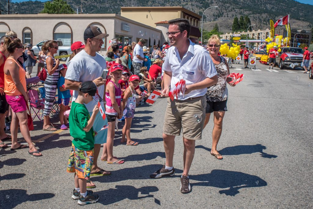 Federal Conservative candidate Marshall Neufeld was handing out Canadian flags in the Cherry Fiesta parade. (Richard McGuire photo)
