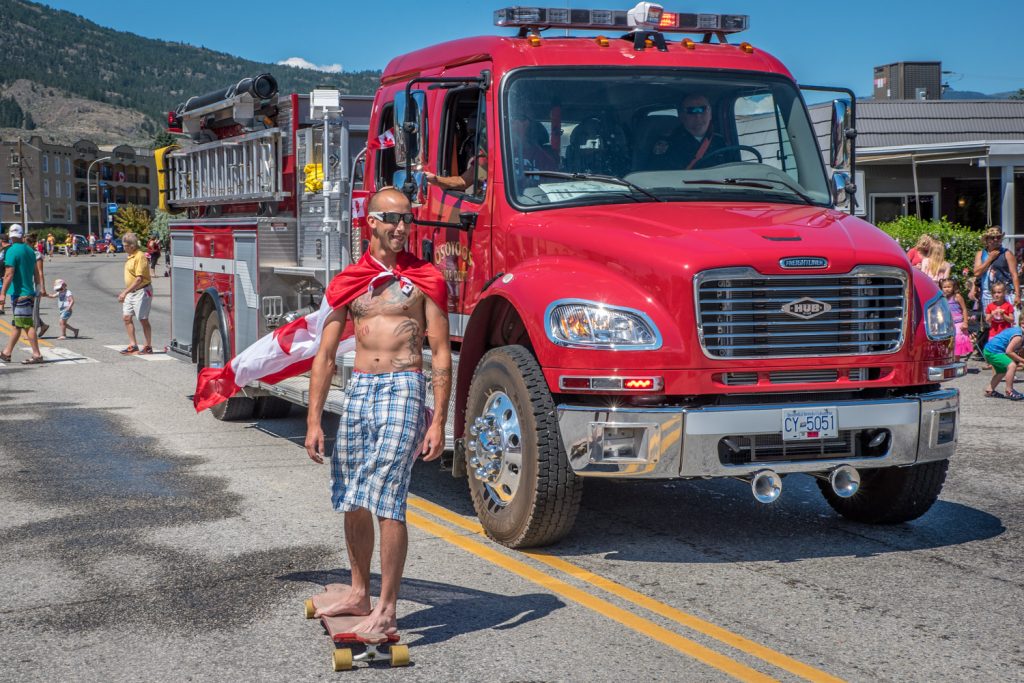 A skateboarder easily passes a fire engine coming down the hill on Main Street during the Cherry Fiesta parade. (Richard McGuire photo)