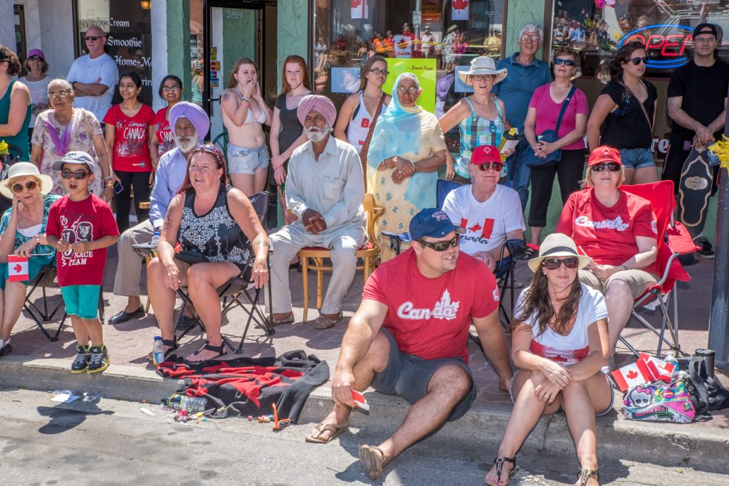Spectators watch as the Cherry Fiesta parade passes along Main Street. (Richard McGuire photo)