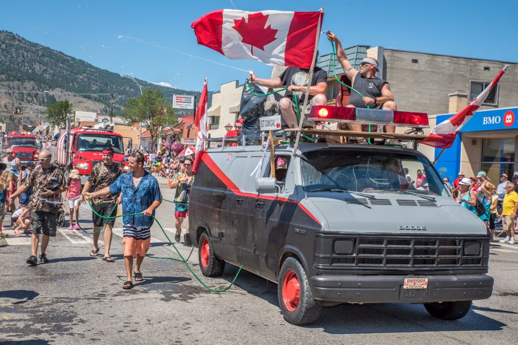 Members of the Osoyoos Fire Department spray spectators with cool water during the Cherry Fiesta parade. (Richard McGuire photo)