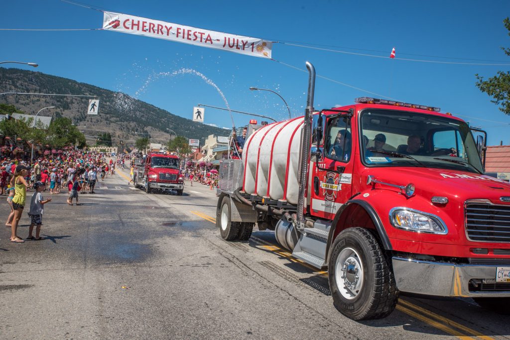 The Anarchist Mountain Fire Department sprays water at spectators during the Cherry Fiesta parade. (Richard McGuire photo)