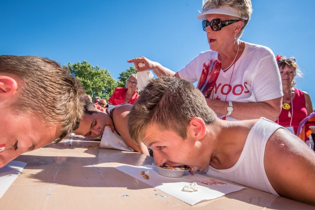 Mayor Sue McKortoff points to a potential winner as she helps to run the cherry pie eating contest during Cherry Fiesta. (Richard McGuire photo)