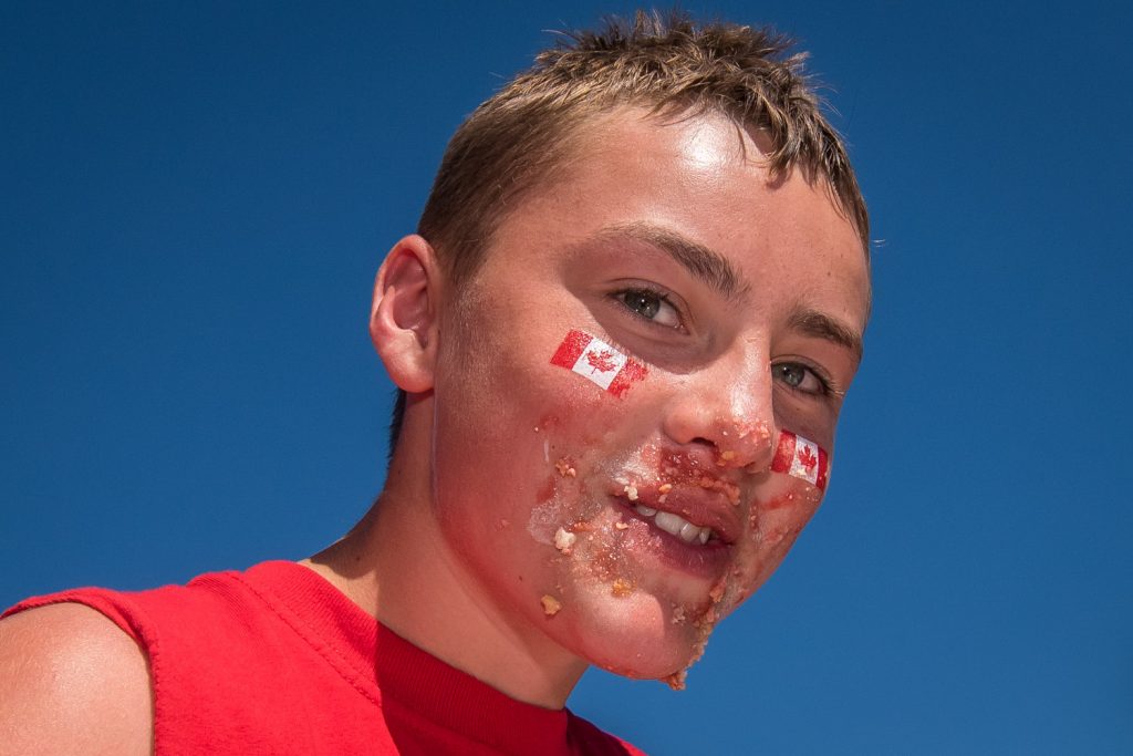 With cherry pie clinging to his face, this young man seems proud of his performance in the cherry pie eating contest at Cherry Fiesta, (Richard McGuire photo)