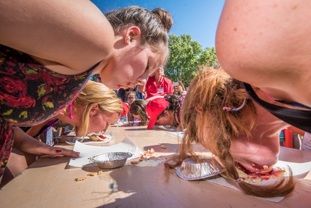 Female contestants showed they could be just as messy as the men during the cherry pie eating contest at Cherry Fiesta. Contestants raced to each cherry pies with their hands behind their backs. Vanessa Merk (left) took first place while Willow Macdonald (right) won second. (Richard McGuire photo)