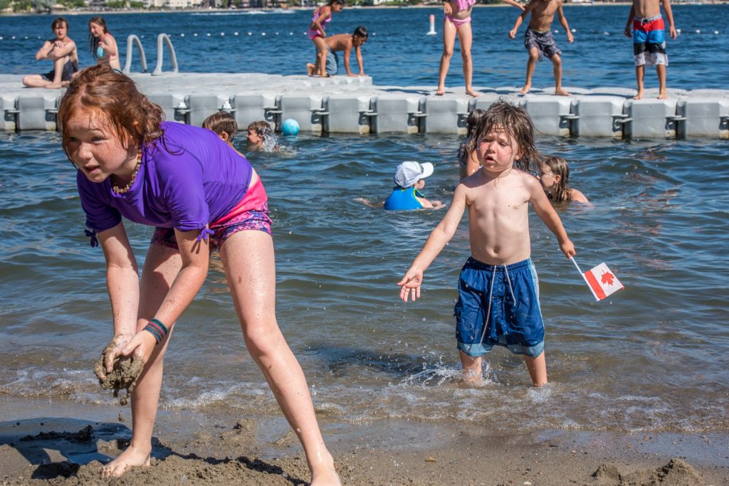 Children play on Gyro Beach in the warm July 1 sunshine. (Richard McGuire photo)