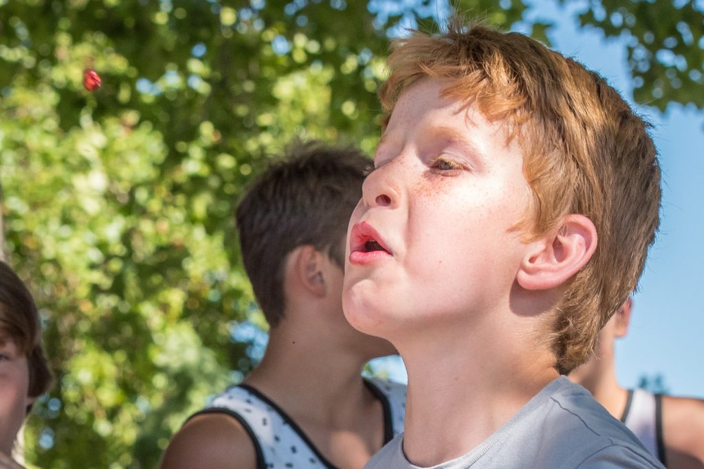 Bronson Macdonald, of Brooks, Alta., fires a cherry pit in the cherry pit spitting contest at Cherry Fiesta. (Richard McGuire photo)