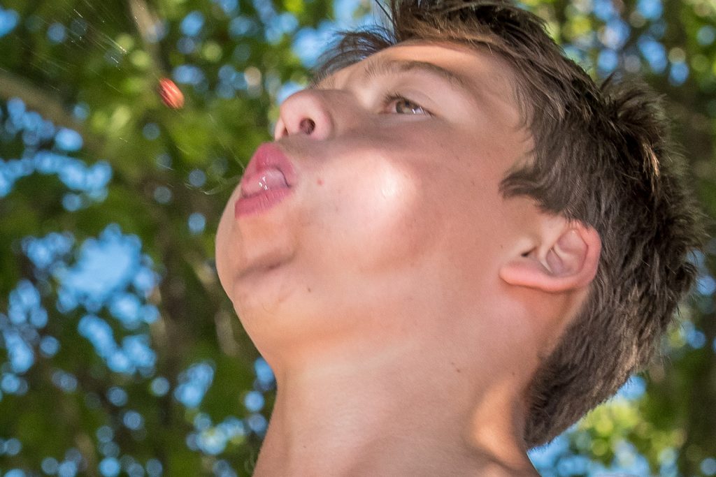 Jordan Brett, of Calgary, spits a cherry pit during the cherry pit spitting contest at Cherry Fiesta. (Richard McGuire photo)