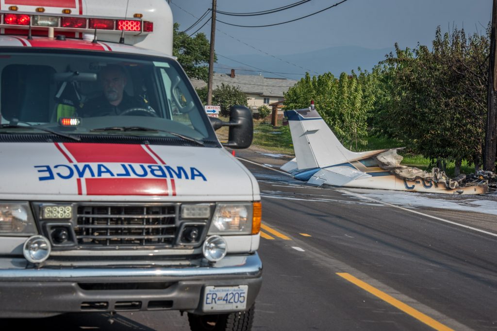 An ambulance stands by. Witnesses said another ambulance transported the pilot, who was alive after the crash. There is no official word on the pilot's condition. (Richard McGuire photo)