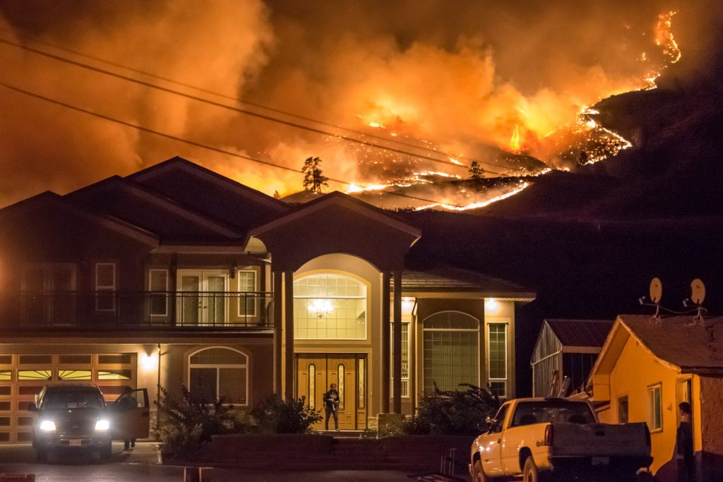 People prepare to evacuate homes along Highway 97 as the Testalinden fire rapidly approached just before 10 p.m. (Richard McGuire photo)