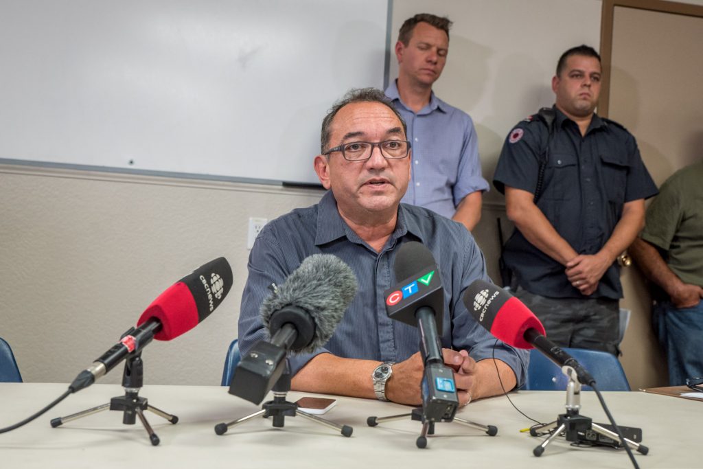 Oliver Mayor Ron Hovanes became emotional when he thanked firefighters during a news conference on Saturday. Behind him is Mark Woods, from the RDOS, who has been working long hours to co-ordinate the Emergency Operation Centre in Oliver and Rob Graham, spokesperson for the Oliver Fire Department. (Richard McGuire photo)