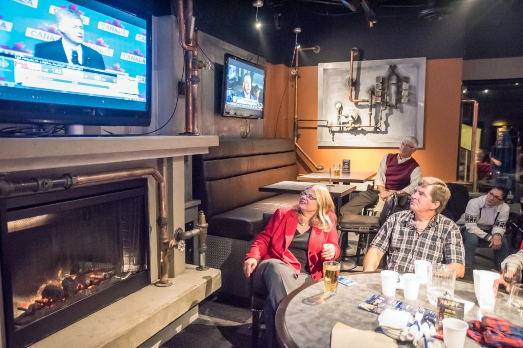 Liberal candidate Connie Denesiuk watches Conservative Leader Stephen Harper concede defeat in a bar with her supporters in Penticton. (Richard McGuire photo)