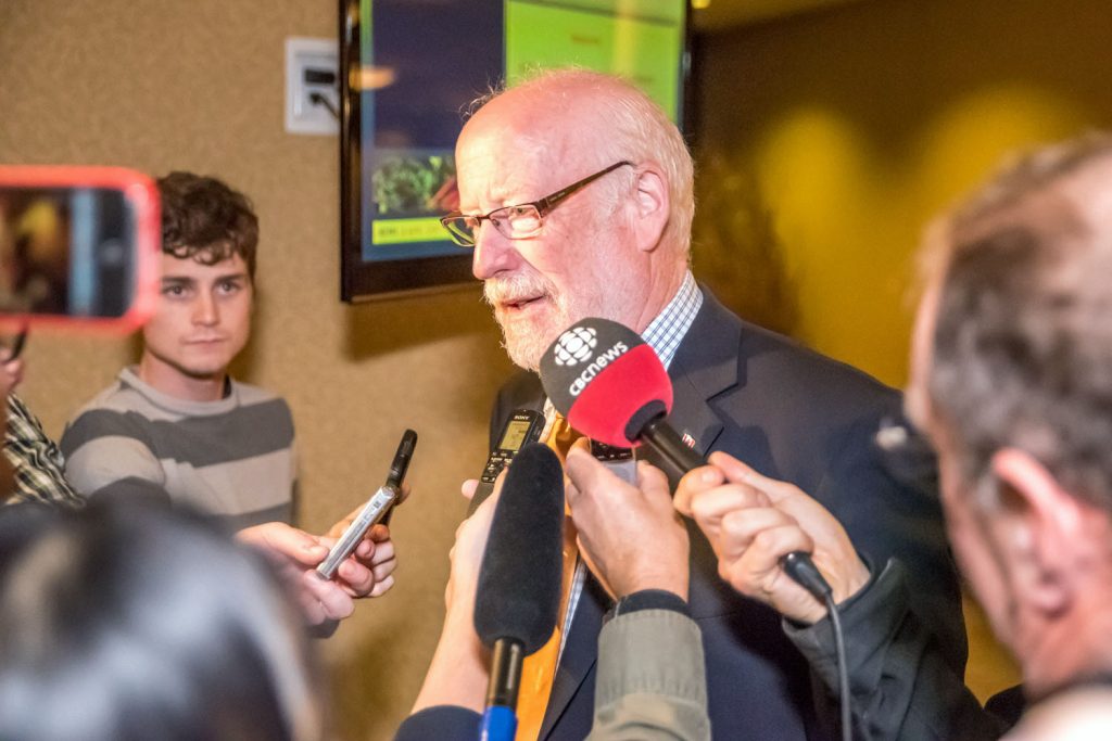 Richard Cannings is scrummed by reporters as he makes his way to the conference room where his suppoters are waiting. (Richard McGuire photo)