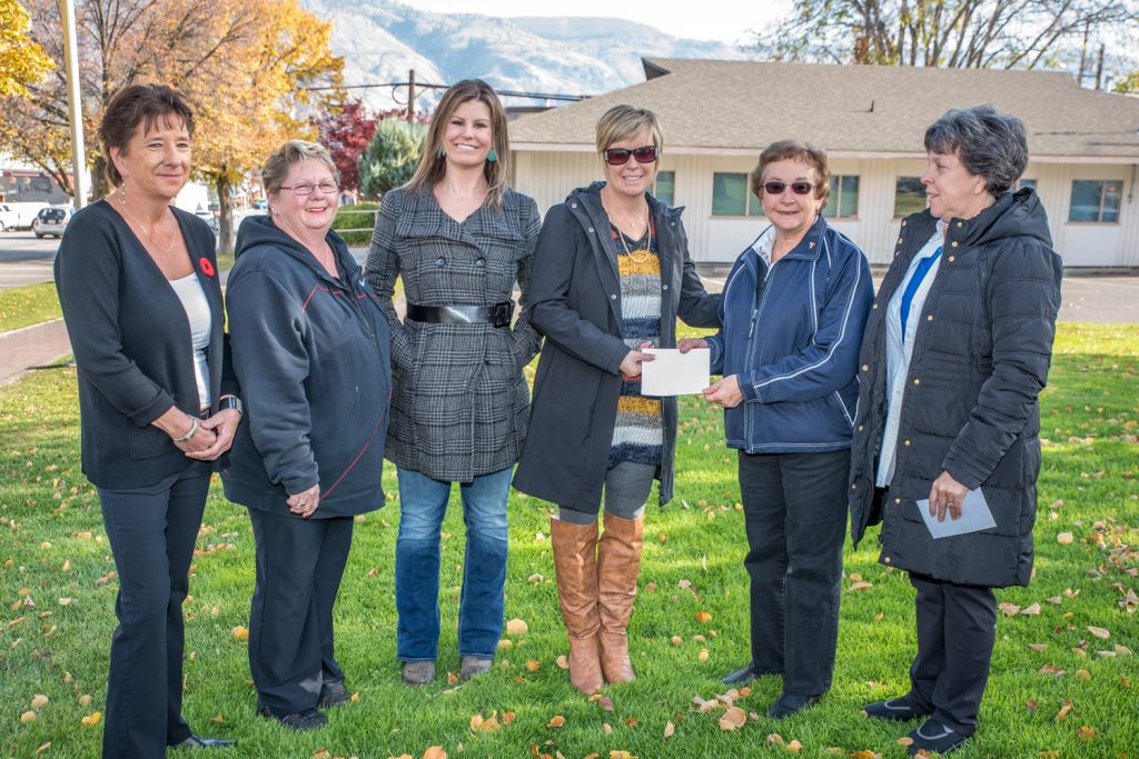Sandy Summers, fourth from left, presents $31,000 to Joyce Evans of the Rock Creek/Westbridge Fire Unmet Needs Committee. From left are Millie Jarrett, manager Best Western Sunrise Inn; Annette Star, Osoyoos Elks Club; Sannah Fletcher, In The Loop; Summers; Evans and Deb Millett, also of the Unmet Needs Committee. (Richard McGuire photo)