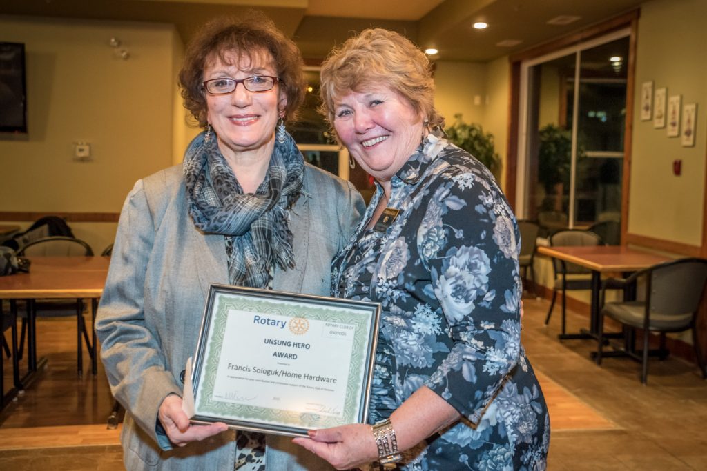 Cheryle King (right) presents the Rotary Unsung Hero Award to Frances Sologuk, owner of Osoyoos Home Hardware. The same award was presented to Brian Fry, manager of Buy-Low Foods, who could not be present at the Osoyoos Rotary Club's Mix and Mingle event last Thursday. (Richard McGuire photo)