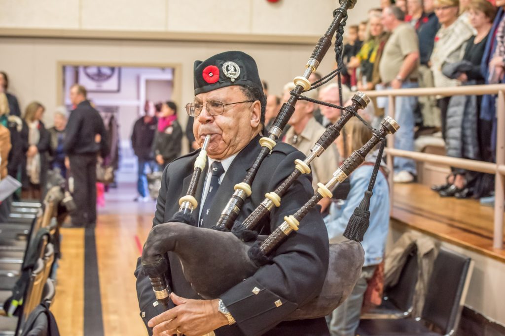 Piper John Birnie follows the colour party into the gym at the Sonora Community Centre at the start of Wednesday's Remembrance Day service. (Richard McGuire photo)