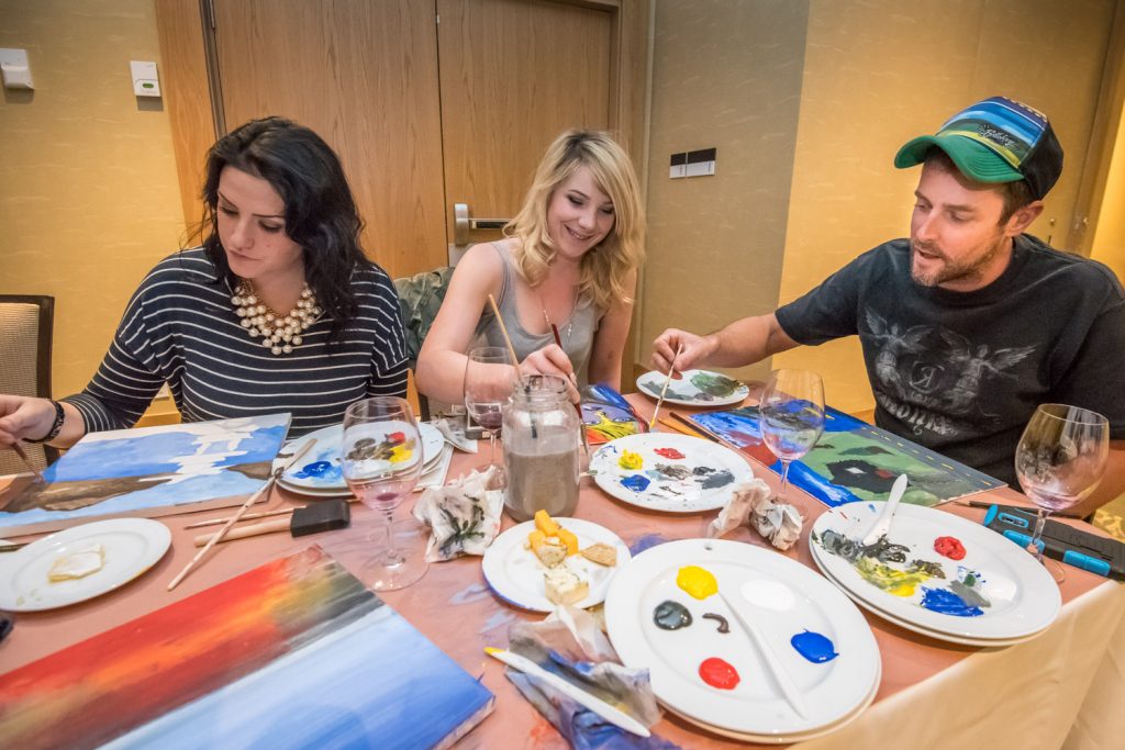 Caitlyn Kostynuk (left), Enola Holmes and Geoff Nickson were among the budding artists turning our Saturday evening for the Paint and Sip fundraiser for the Osoyoos Lake Water Quality Society. The social event with wine tasting was held at the Watermark Beach Resort. (Richard McGuire photo)