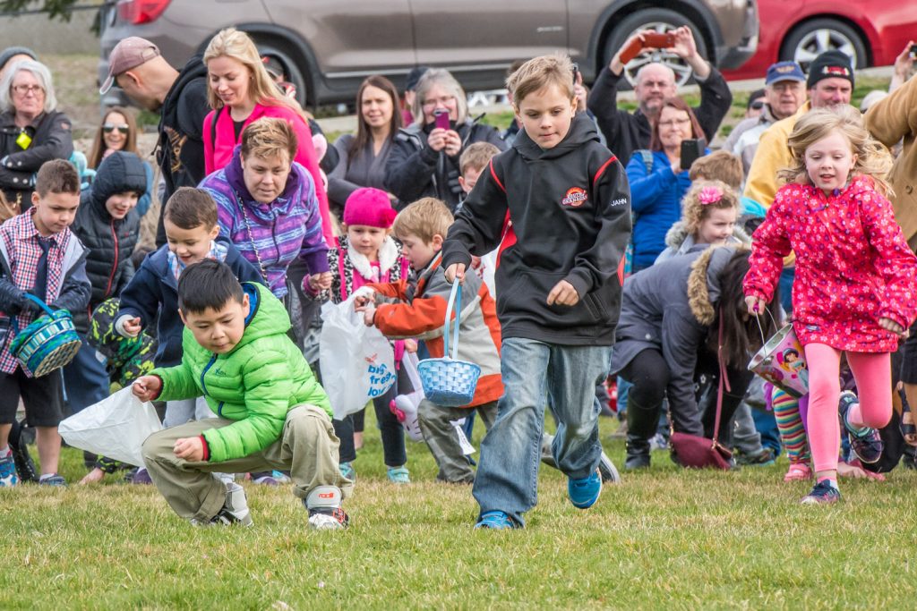 A split seconds after the "go" signal, children race out to gather candy Easter eggs in the hunt. (Richard McGuire photo)