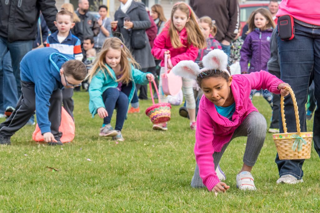 Children comb every inch of the lower school yard in an Easter egg frenzy scooping up the candy eggs. Some children wore bunny ears. (Richard McGuire photo)
