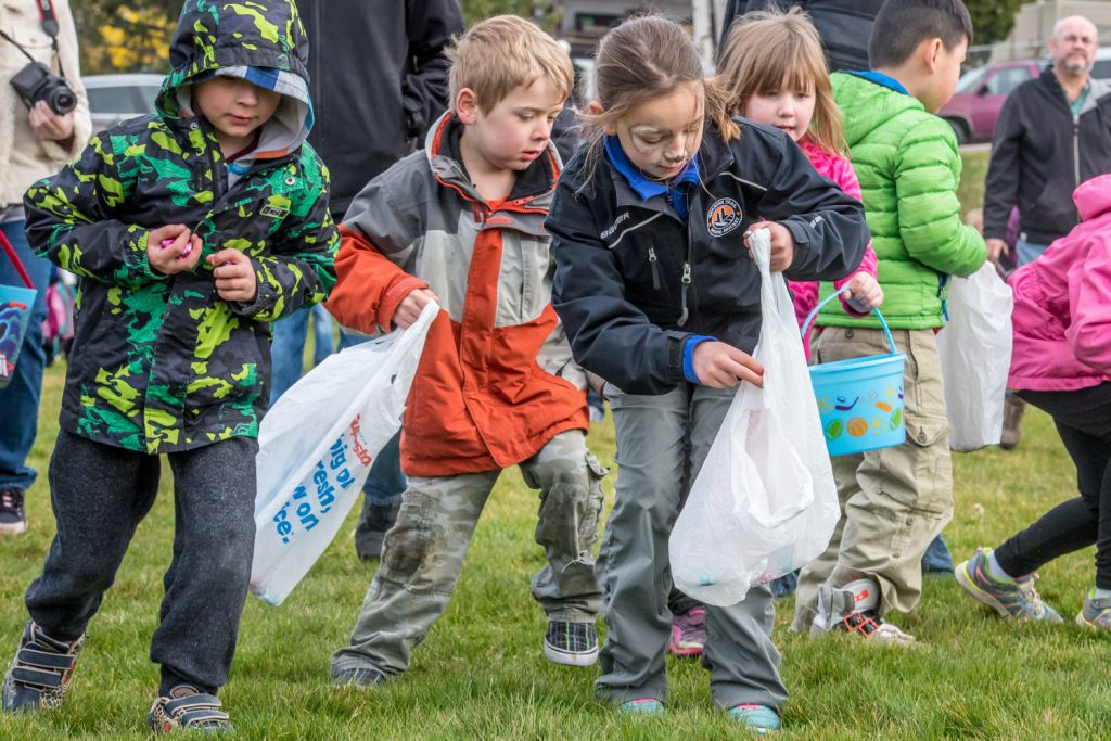 Children had different ways to carry their Easter egg loot in the Easter Eggstravaganza egg hunt. Some used hands, others pockets, some brought grocery bags, others buckets or Easter baskets. (Richard McGuire photo)
