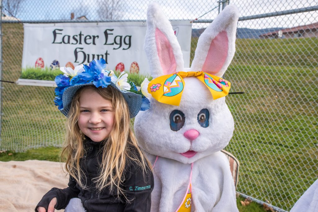 Wearing a beautiful blue Easter bonnet, Crystal Zimmerman sits on the Easter Bunny's lap. (Richard McGuire photo)