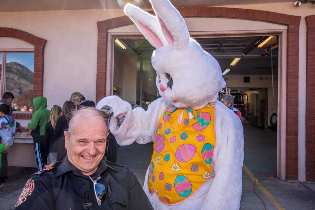 The Easter Bunny, aka Ken Baker of the Osoyoos Times, gives firefighter Colin Lancaster a "hare cut." The Osoyoos firefighters were getting their heads shaved and selling hot dogs to raise money for the Canadian Cancer Society. (Richard McGuire photo)