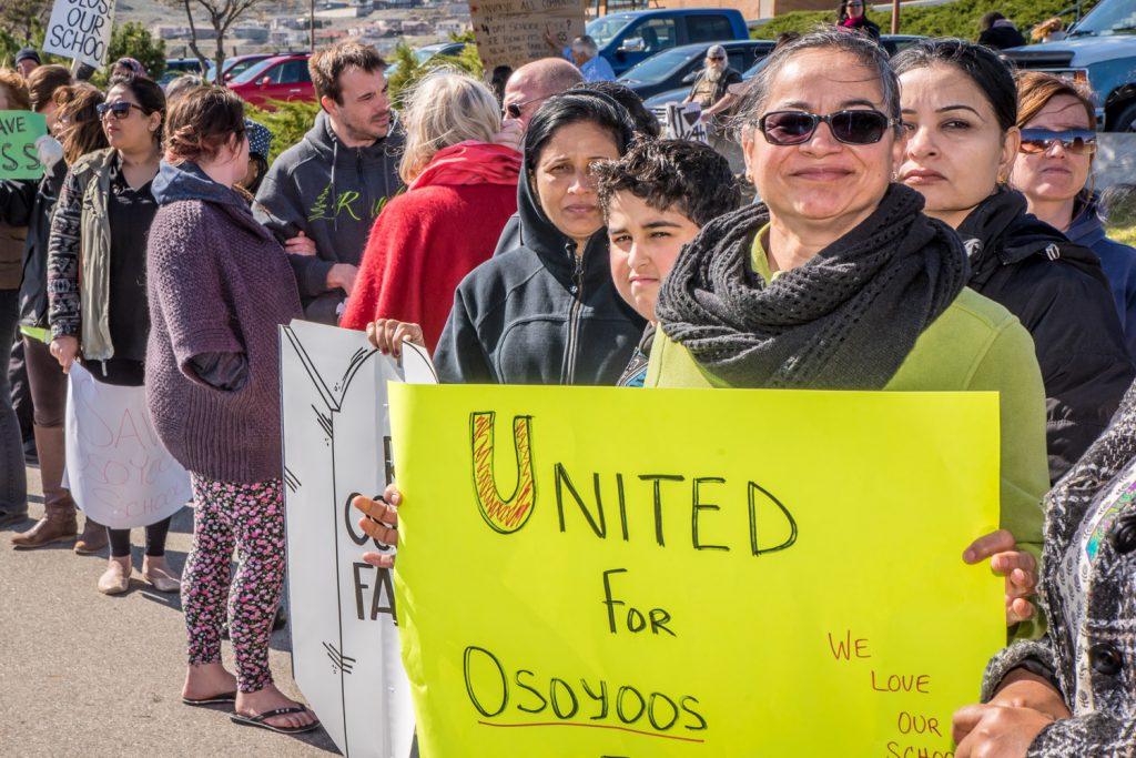 Many people carried placards proclaiming their love for Osoyoos schools and warning of sectors of the community that would be devastated by the closure of either school. (Richard McGuire photo)