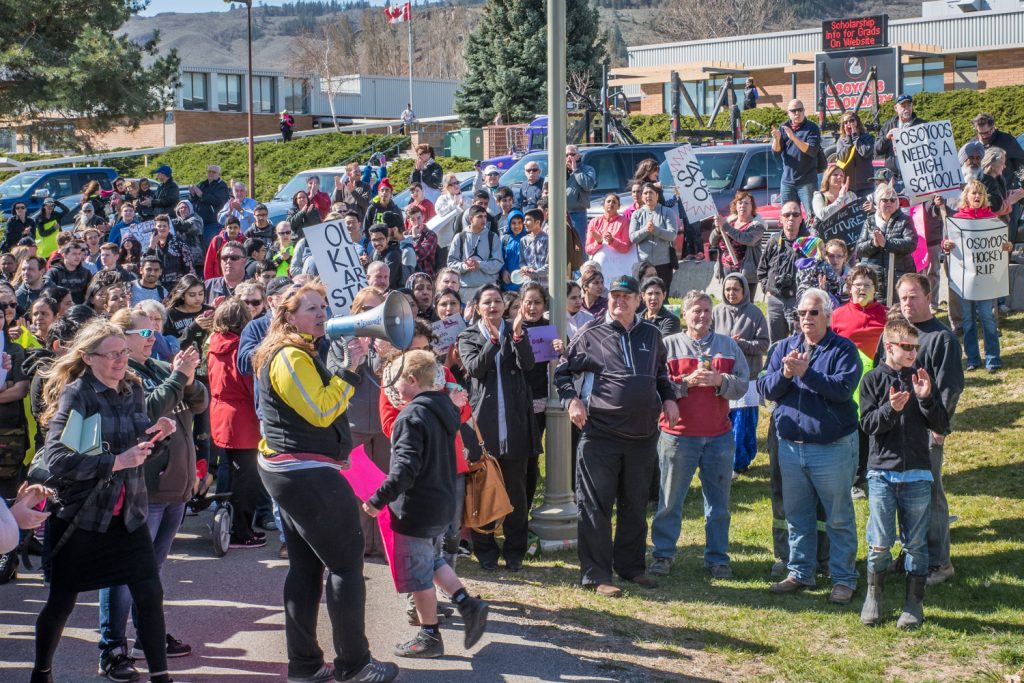 Brenda Dorosz, chair of the Save Our Schools (SOS) committee shouts through a megaphone to be heard above the chants and honking horns. Several hundred local resident, including students, turned out Tuesday morning at Osoyoos Secondary School to protest the proposed school closure. (Richard McGuire photo)