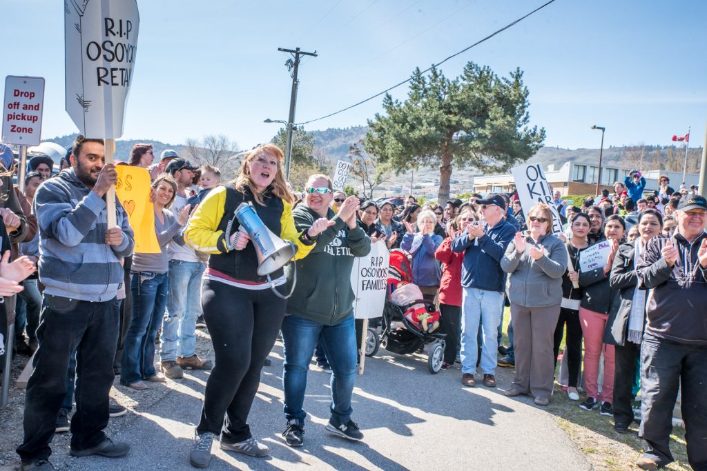 Hundreds of local residents turned out Tuesday morning to show their support for keeping Osoyoos schools open. The rally at Osoyoos Secondary School was organized by Brenda Dorosz (with megaphone) and other members of her Save Our Schools (SOS) committee. (Richard McGuire photo)