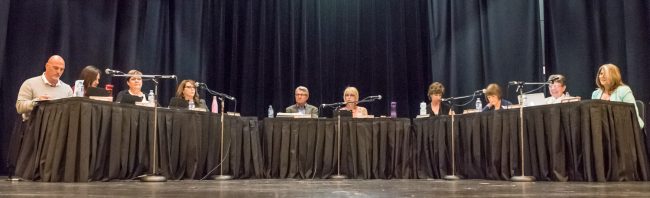 Trustees take their seats at the very back of the stage as they prepare to vote on closing Osoyoos Secondary School. (Richard McGuire photo)