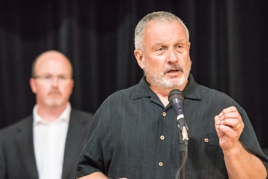 Coun. C.J. Rhodes spoke as acting mayor at the meeting. He said the town is looking at several legal options to keep Osoyoos Secondary School open and he urged residents not to give up. (Richard McGuire photo)