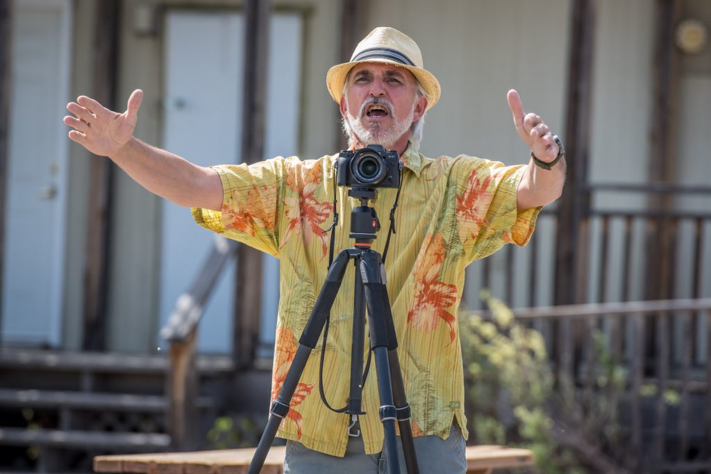 Peter Hovestad, of the Osoyoos Photography Club, led a photo walk on Saturday at the Osoyoos Desert Centre on its opening day of the season. Shown here, he directs participants to move closer together for a group photo. (Richard McGuire photo)
