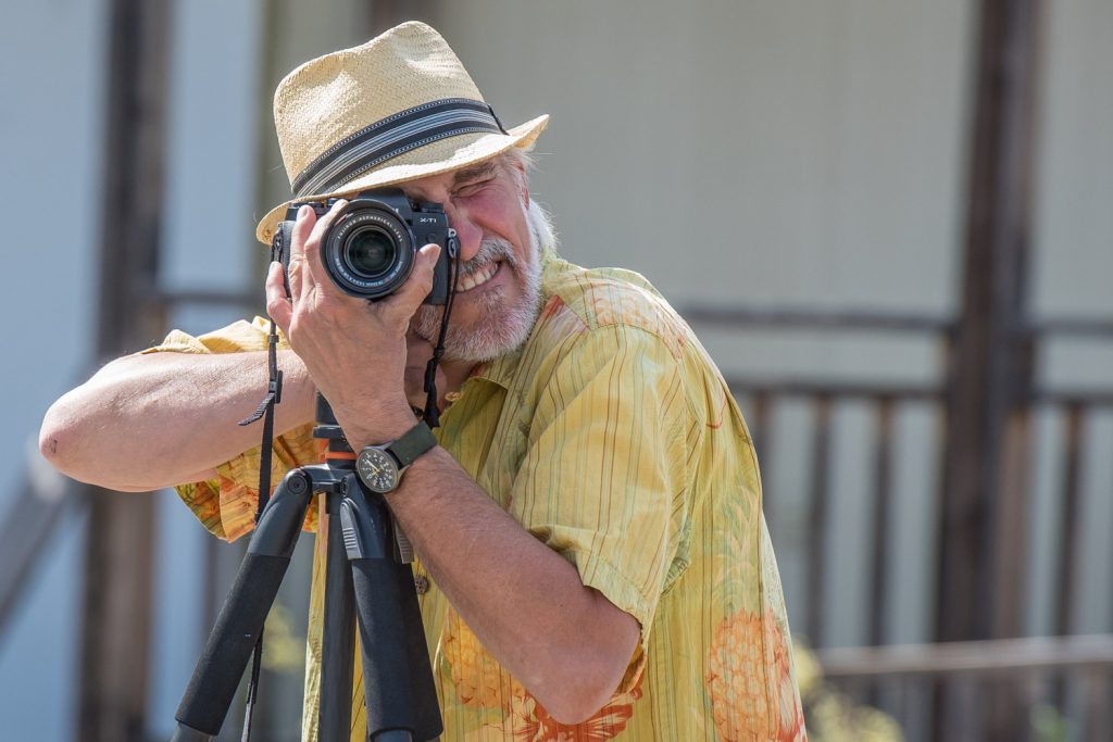 Peter Hovestad, of the Osoyoos Photography Club, led a photo walk on Saturday at the Osoyoos Desert Centre on its opening day of the season. Shown here, he frames a group shot before getting into the photo himself. (Richard McGuire photo)