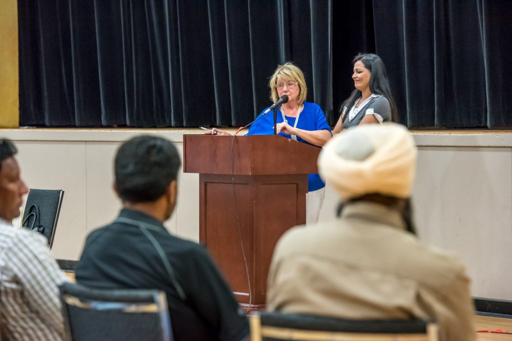 Councillor Carol Youngberg speaks while Kuldeep Rai stands ready to interpret her remarks in Punjabi at a meeting Wednesday night to inform the Osoyoos-area Indo-Canadian community about efforts to establish an independent school. (Richard McGuire photo)