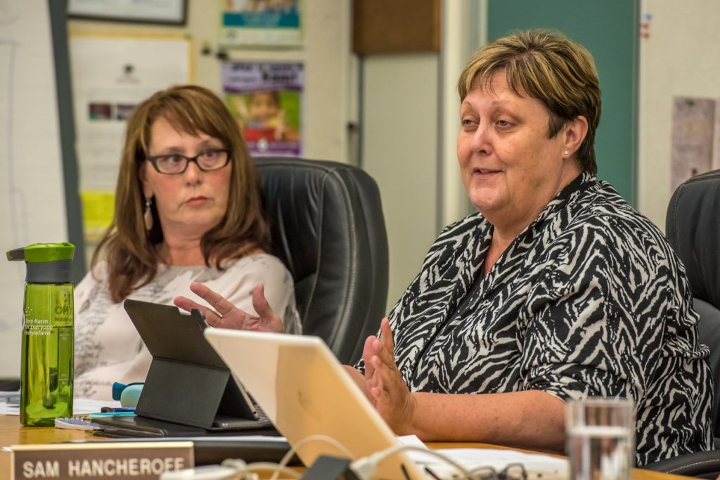 Debbie Marten (right), one of two trustees for Cawston-Keremeos, expresses her views on a motion by trustee Sam Hancheroff to apply for provincial funding to save Osoyoos Secondary School. Marten had concerns that the government might not provide the funding in coming years, leaving trustees in the same situation, but she voted in favour of applying nonetheless. Bev Young, superintendent of schools (left) listens. (Richard McGuire photo)