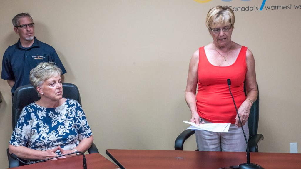 MLA Linda Larson announces $490,000 in provincial funding to keep Osoyoos Secondary School open. At left, Councillor Mike Campol and Mayor Sue McKortoff listed to the announcement. (Richard McGuire photo)
